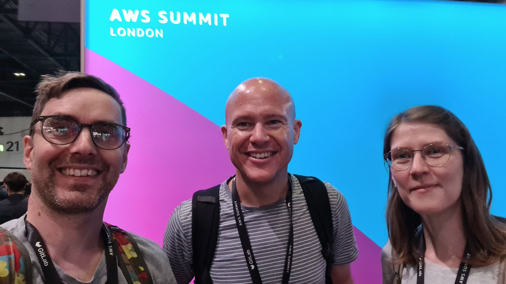 Andrew Dodson, Robert Mackenzie and Sarah Houben in front of the AWS Summit London sign